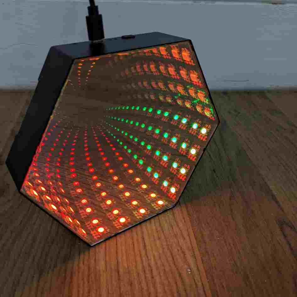 hexagonal infinity mirror light with red and green lights inside