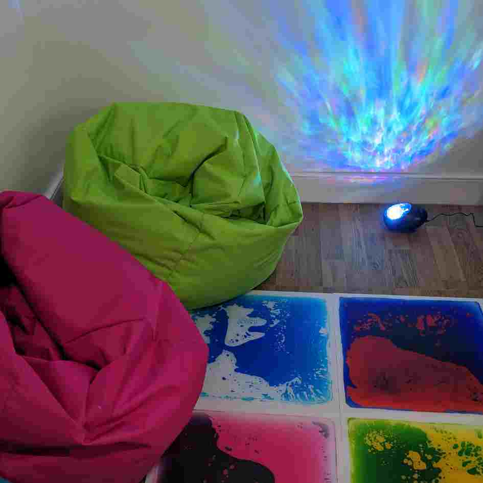 bean bags and galaxy projector light with liquid floor tiles